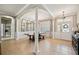 Elegant dining room featuring tile floors, architectural columns, and a modern chandelier at 7088 Remington Oaks Loop, Lakeland, FL 33810