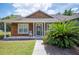 Charming single-story home with wood siding and lush landscaping creates a welcoming curb appeal at 7088 Remington Oaks Loop, Lakeland, FL 33810