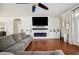 Cozy living room featuring a fireplace, shiplap accent wall, and hardwood floors at 7088 Remington Oaks Loop, Lakeland, FL 33810