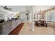 Open-concept living space with tile and hardwood floors seamlessly connecting the living and dining areas at 7088 Remington Oaks Loop, Lakeland, FL 33810