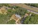 Aerial shot showcasing the property's location near the highway and surrounded by mature trees at 7208 Thomas Jefferson Cir, Bartow, FL 33830