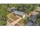 Aerial view of home with a metal roof, adjacent buildings, and nearby mature trees at 7208 Thomas Jefferson Cir, Bartow, FL 33830