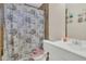 Cozy bathroom with floral shower curtain, and classic white sink at 7208 Thomas Jefferson Cir, Bartow, FL 33830