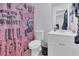 Bathroom featuring a spooky shower curtain, modern sink and a classic toilet at 7208 Thomas Jefferson Cir, Bartow, FL 33830