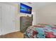 Bedroom with a mounted tv, dresser, and a glimpse of the bed at 7208 Thomas Jefferson Cir, Bartow, FL 33830