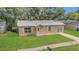 Charming home with a well-maintained front yard, metal roof, and inviting entrance at 7208 Thomas Jefferson Cir, Bartow, FL 33830