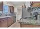 A functional kitchen featuring dark cabinetry, granite countertops and modern appliances at 7208 Thomas Jefferson Cir, Bartow, FL 33830