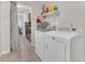 Bright laundry room with modern washer and dryer, and shelf storage at 7208 Thomas Jefferson Cir, Bartow, FL 33830