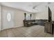 An open living room with tile floors and a large sectional sofa for ample seating at 7208 Thomas Jefferson Cir, Bartow, FL 33830
