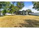 Expansive backyard features a screened-in pool and mature landscaping, perfect for outdoor activities at 781 Bryson Loop, Lakeland, FL 33809