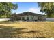 Expansive backyard features a screened-in pool and mature landscaping, offering privacy at 781 Bryson Loop, Lakeland, FL 33809