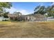 Expansive backyard features a screened-in pool and mature landscaping, offering privacy at 781 Bryson Loop, Lakeland, FL 33809
