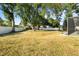 Expansive backyard featuring a white fence, mature trees, and ample space for outdoor activities and recreation at 781 Bryson Loop, Lakeland, FL 33809