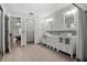 Bathroom boasts tile floors, dual sinks and cabinets, framed mirrors, and a tiled shower with a glass door at 781 Bryson Loop, Lakeland, FL 33809