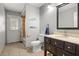 This bathroom has tile floors, a modern sink and mirror, and a shower-tub combination with a tiled surround at 781 Bryson Loop, Lakeland, FL 33809