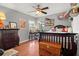 Nicely decorated bedroom with hard wood floors, a ceiling fan, natural light, and a view to the neighborhood at 781 Bryson Loop, Lakeland, FL 33809