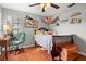 Cozy bedroom features hardwood floors, a ceiling fan, and a workspace, creating a comfortable and functional space at 781 Bryson Loop, Lakeland, FL 33809