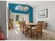 Dining room with blue accent wall, pendant lighting, and door to the exterior at 781 Bryson Loop, Lakeland, FL 33809