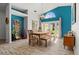 Bright dining space with wood floors, modern lighting, blue wall, and backyard access at 781 Bryson Loop, Lakeland, FL 33809