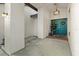 Inviting entryway with double turquoise doors, brick pavers, and modern lighting at 781 Bryson Loop, Lakeland, FL 33809