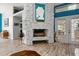 Living room showing a painted stone fireplace with hearth, wood floors and an entry to dining space at 781 Bryson Loop, Lakeland, FL 33809