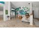 Open living room boasts natural light, a painted accent wall, and wood-look floors at 781 Bryson Loop, Lakeland, FL 33809