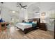 Bright, open bedroom features vaulted ceilings, a ceiling fan, wood floors, and French doors to the outside at 781 Bryson Loop, Lakeland, FL 33809