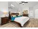 Spacious bedroom with wood floors, a ceiling fan, a large mirror, and plenty of room for bedroom furniture at 781 Bryson Loop, Lakeland, FL 33809