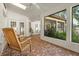 Spacious screened-in patio with tile floor, rocking chairs, and view to backyard at 781 Bryson Loop, Lakeland, FL 33809