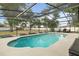 A sparkling in-ground pool with screened enclosure and lush backyard provides a relaxing outdoor space at 781 Bryson Loop, Lakeland, FL 33809