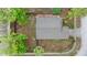 Aerial view of a home surrounded by mature trees, showcasing the roof and landscaping at 7952 Grand Pines Blvd, Lakeland, FL 33810
