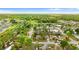 Aerial view of this home nestled within a community dotted with mature trees and verdant lawns at 7952 Grand Pines Blvd, Lakeland, FL 33810