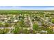 A scenic aerial view showcasing the home's location within a charming, tree-lined neighborhood at 7952 Grand Pines Blvd, Lakeland, FL 33810