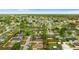 Aerial view of the home surrounded by a neighborhood, with mature trees and green lawns at 7952 Grand Pines Blvd, Lakeland, FL 33810