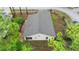 Aerial view of this single-Gathering home with a patio, complemented by lush greenery and landscaping at 7952 Grand Pines Blvd, Lakeland, FL 33810