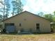 The backyard features a level lawn and exterior walls at 7952 Grand Pines Blvd, Lakeland, FL 33810