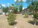 The backyard has lush landscaping, and a fence surrounds the perimeter at 7952 Grand Pines Blvd, Lakeland, FL 33810
