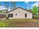 The backyard features a spacious lawn and a screened-in patio at 7952 Grand Pines Blvd, Lakeland, FL 33810