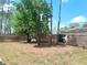 Backyard with tall trees and chainlink fence at 7952 Grand Pines Blvd, Lakeland, FL 33810