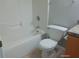 Clean bathroom featuring a combined tub and shower with toilet and vanity with storage at 7952 Grand Pines Blvd, Lakeland, FL 33810
