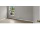 Small bedroom features a large window and tile flooring at 7952 Grand Pines Blvd, Lakeland, FL 33810