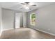 Bright bedroom features tile floors, a ceiling fan, and a view to the landscaped outdoors at 7952 Grand Pines Blvd, Lakeland, FL 33810