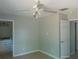 This bedroom features neutral paint, tile flooring, and a ceiling fan with lighting at 7952 Grand Pines Blvd, Lakeland, FL 33810
