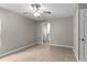 Neutral bedroom with tile floors, ceiling fan, and ensuite bathroom at 7952 Grand Pines Blvd, Lakeland, FL 33810