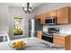 Bright kitchen features stainless steel appliances, wood cabinets, marble countertops and view to the backyard at 7952 Grand Pines Blvd, Lakeland, FL 33810
