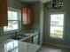 Bright kitchen with stainless steel appliances, double sink, and wooden cabinetry with a marble countertop at 7952 Grand Pines Blvd, Lakeland, FL 33810