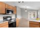 Open kitchen with stainless steel appliances and counter seating flows into a bright, airy living space at 7952 Grand Pines Blvd, Lakeland, FL 33810
