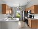Well-lit kitchen boasts stainless steel appliances, stone countertops, and a view of the backyard at 7952 Grand Pines Blvd, Lakeland, FL 33810