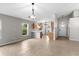 Open-concept living area with tile floors, neutral walls, and a view into the kitchen at 7952 Grand Pines Blvd, Lakeland, FL 33810