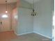 Spacious living room with neutral paint, tile floors, and a chandelier, offering a versatile living space at 7952 Grand Pines Blvd, Lakeland, FL 33810